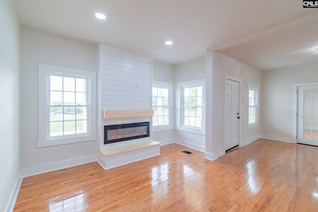 unfurnished living room with light wood-style flooring, recessed lighting, baseboards, and visible vents