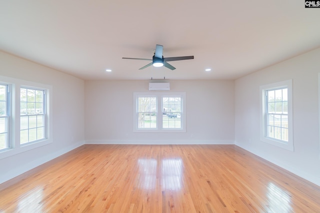 unfurnished room with baseboards, light wood-style floors, and a healthy amount of sunlight