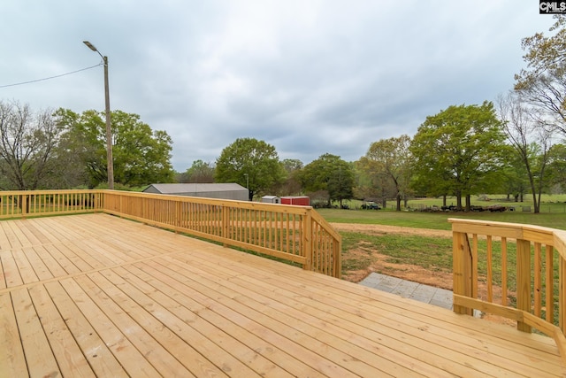 wooden deck featuring a lawn