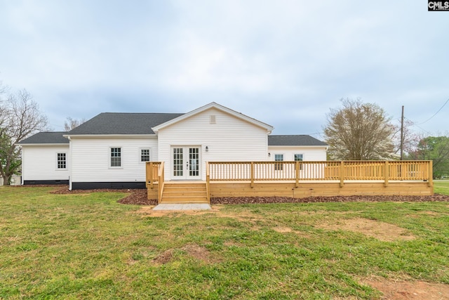 rear view of house with crawl space, a deck, roof with shingles, a lawn, and french doors