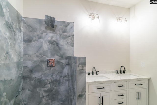 full bath featuring double vanity, a shower, and a sink