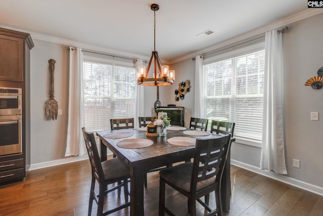 232 Compass Trl, Blythewood, SC 29016 - dining area with plenty of natural light, a notable chandelier, crown molding, and dark wood finished floors
