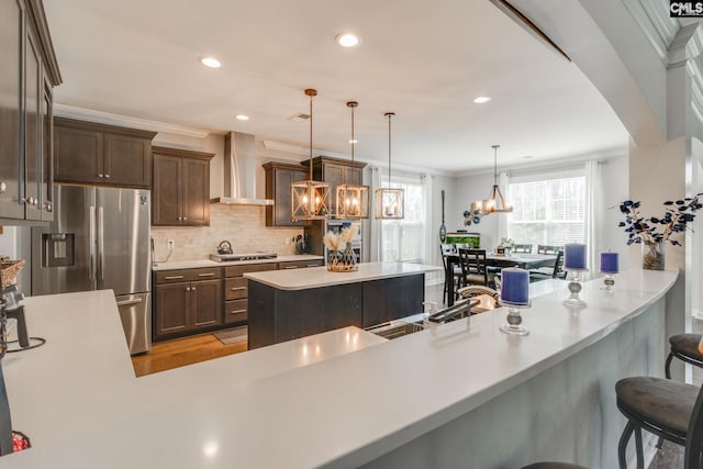 232 Compass Trl, Blythewood, SC 29016 - kitchen with an inviting chandelier, backsplash, crown molding, wall chimney exhaust hood, and stainless steel appliances