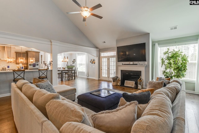 232 Compass Trl, Blythewood, SC 29016 - living area featuring a glass covered fireplace, arched walkways, ceiling fan with notable chandelier, and wood finished floors