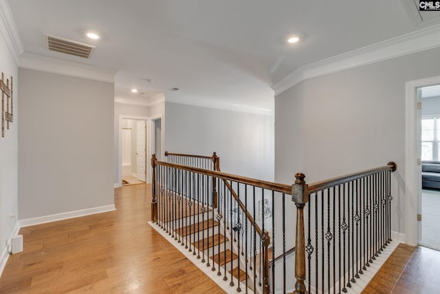 232 Compass Trl, Blythewood, SC 29016 - hall with baseboards, ornamental molding, an upstairs landing, light wood-style flooring, and visible vents