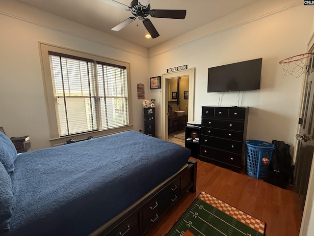 bedroom featuring wood finished floors, ceiling fan, and connected bathroom