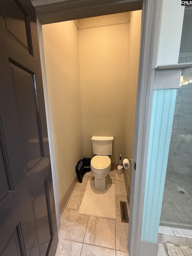 bathroom with visible vents, baseboards, walk in shower, and toilet
