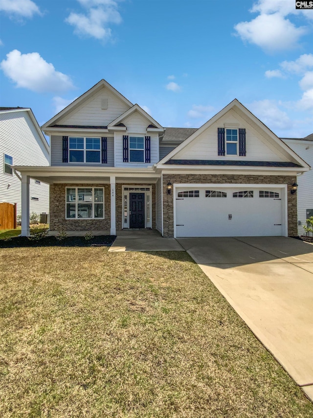 view of front of home with covered porch, stone siding, a front lawn, an attached garage, and concrete driveway