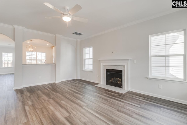 941 Appian Way, Columbia, SC 29229 - unfurnished living room with crown molding, arched walkways, visible vents, wood finished floors, and baseboards