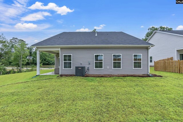 218 Secretariat St, Lexington, SC 29073 - rear view of property featuring a shingled roof, a lawn, fence, cooling unit, and a patio