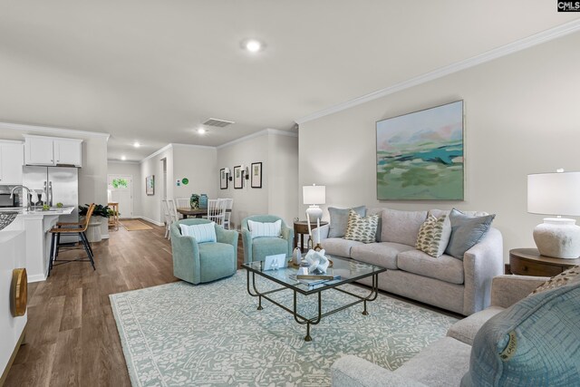 218 Secretariat St, Lexington, SC 29073 - living room with recessed lighting, dark wood-style floors, visible vents, and ornamental molding