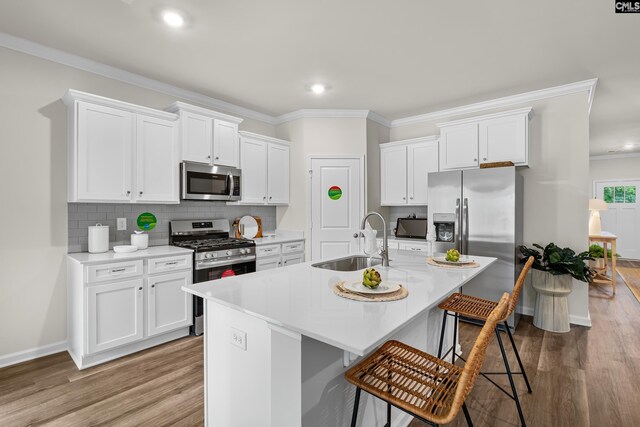 218 Secretariat St, Lexington, SC 29073 - kitchen with wood finished floors, a sink, ornamental molding, and stainless steel appliances