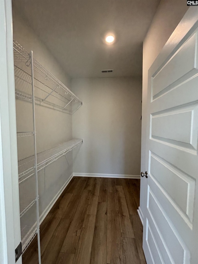 walk in closet with visible vents and wood finished floors