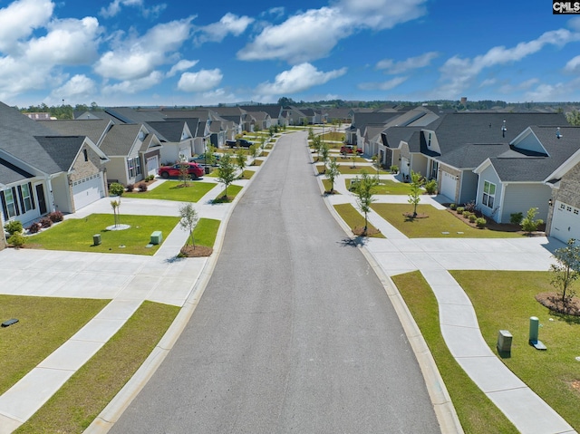 view of road with a residential view, sidewalks, and curbs