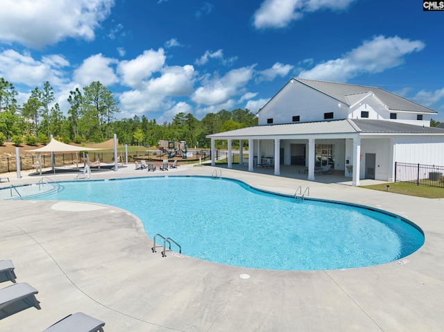pool featuring fence and a patio