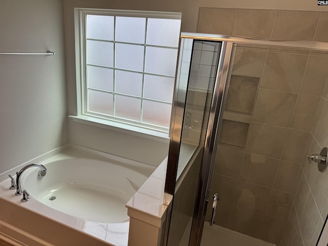 bathroom featuring a garden tub and a stall shower
