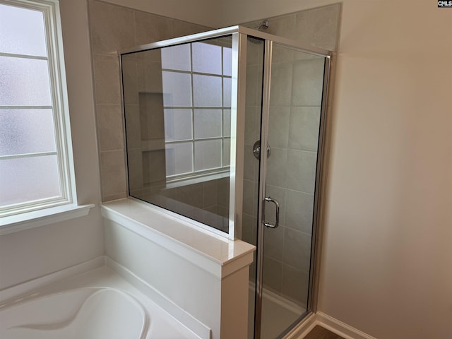 bathroom featuring a bath and a stall shower