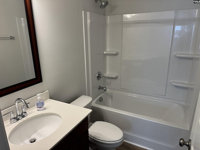bathroom with toilet, shower / bathtub combination, and vanity