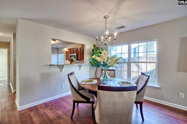 dining space featuring a chandelier, plenty of natural light, visible vents, and dark wood-style floors
