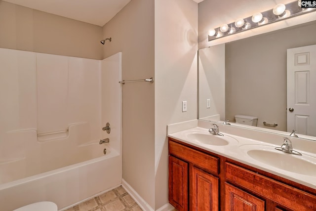 full bathroom featuring a sink, toilet, double vanity, and bathtub / shower combination