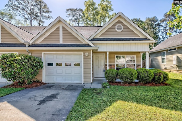 view of front of home with a front yard, a shingled roof, a garage, and concrete driveway