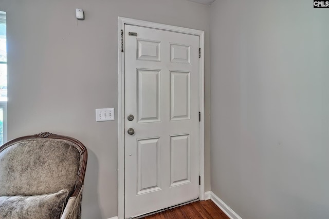 entryway featuring dark wood-style flooring and baseboards