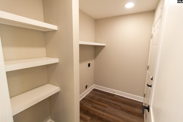 clothes washing area with hookup for an electric dryer, dark wood-style floors, baseboards, and laundry area