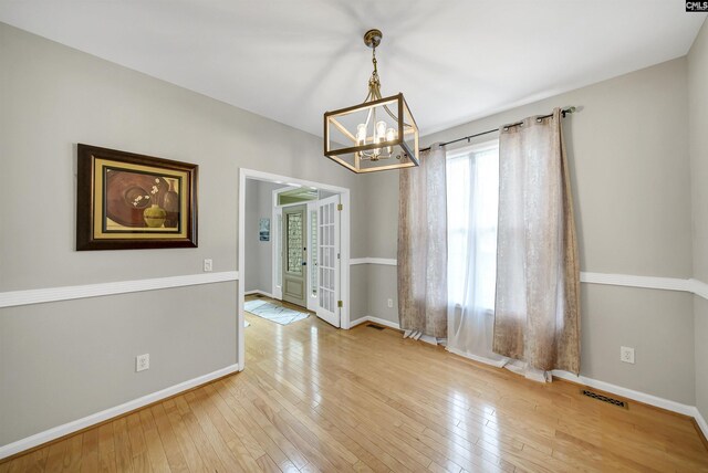 124 Pond Edge Ln, Chapin, SC 29036 - empty room with hardwood / wood-style floors, an inviting chandelier, and baseboards