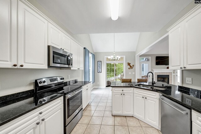 124 Pond Edge Ln, Chapin, SC 29036 - kitchen with light tile patterned floors, vaulted ceiling, appliances with stainless steel finishes, a sink, and a notable chandelier