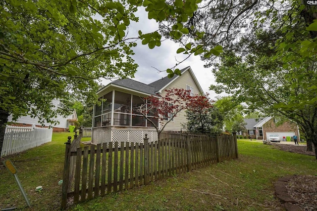 124 Pond Edge Ln, Chapin, SC 29036 - exterior space featuring a shingled roof, fence private yard, a sunroom, and a lawn