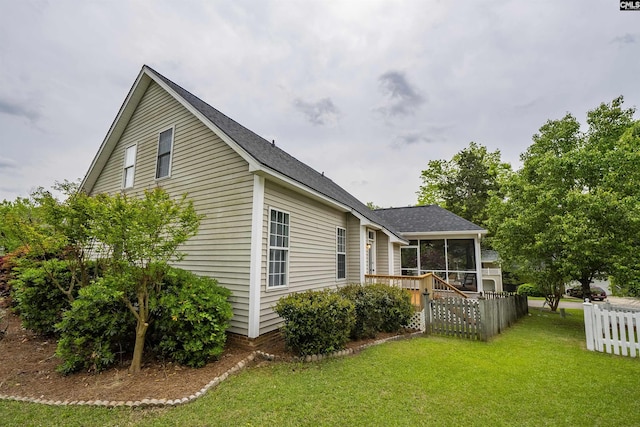 124 Pond Edge Ln, Chapin, SC 29036 - back of property with a shingled roof, a deck, a sunroom, a yard, and fence