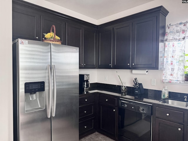 41 Carlisle Ln, Camden, SC 29020 - kitchen with stainless steel fridge, black dishwasher, a sink, dark cabinetry, and tile patterned flooring