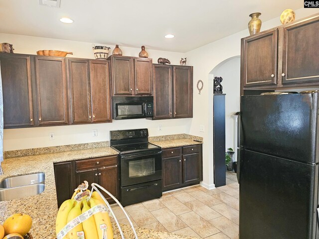 56 Kimpton Dr, Elgin, SC 29045 - kitchen with recessed lighting, dark brown cabinets, black appliances, arched walkways, and a sink