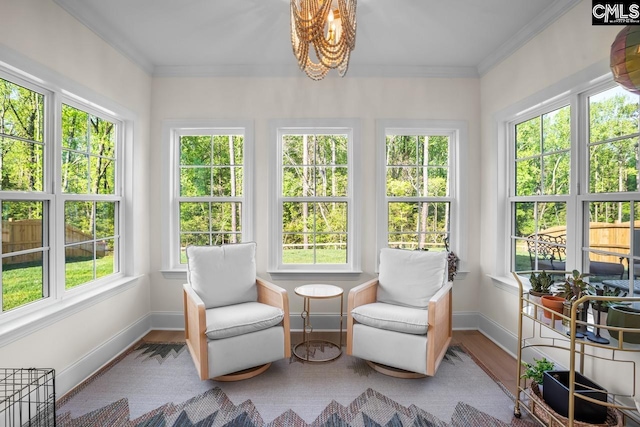 sunroom / solarium featuring an inviting chandelier