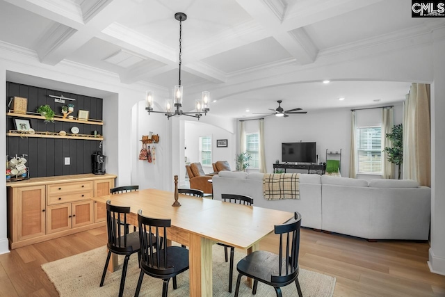 dining room featuring light wood-type flooring, plenty of natural light, coffered ceiling, and ceiling fan with notable chandelier
