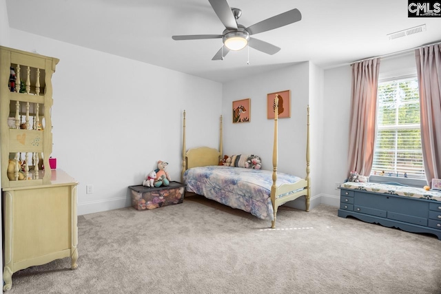 carpeted bedroom with a ceiling fan, visible vents, and baseboards