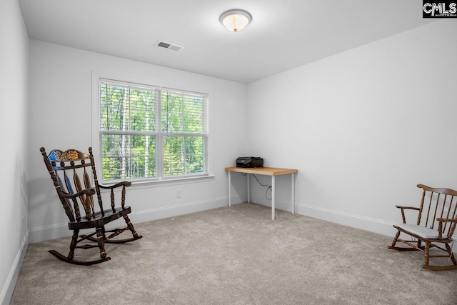 sitting room with visible vents, carpet floors, and baseboards