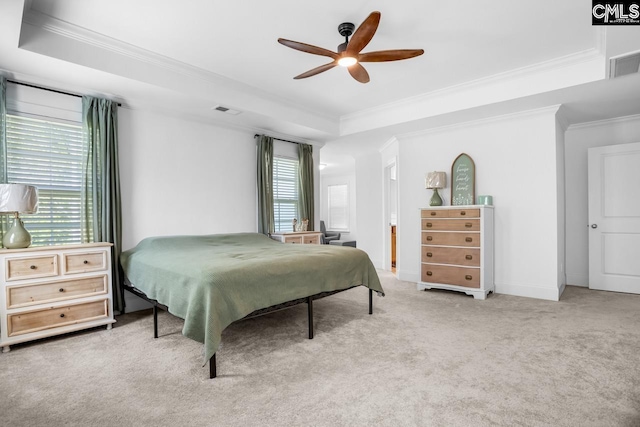 bedroom featuring crown molding, visible vents, carpet floors, and a tray ceiling