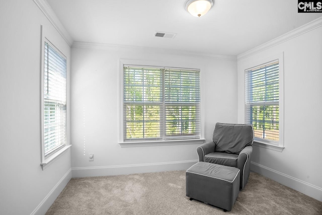 living area with baseboards, visible vents, a healthy amount of sunlight, and carpet floors