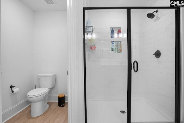 full bath with wood finished floors, toilet, baseboards, visible vents, and a stall shower