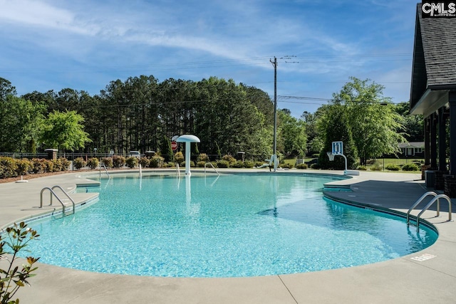 community pool featuring fence and a patio area