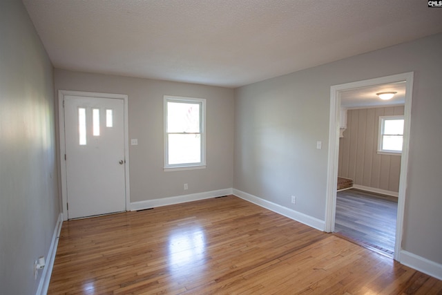 entrance foyer featuring baseboards and light wood finished floors