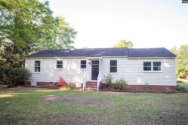 back of property featuring entry steps, crawl space, and a lawn