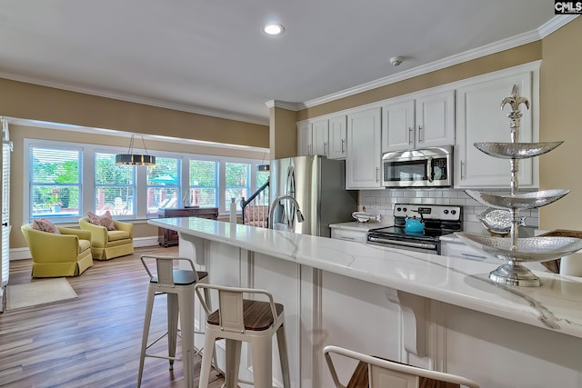209 Mariannas Ct, Lexington, SC 29072 - kitchen with a kitchen bar, crown molding, light stone countertops, and stainless steel appliances