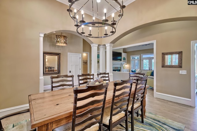 209 Mariannas Ct, Lexington, SC 29072 - dining space featuring baseboards, arched walkways, a high ceiling, ornamental molding, and ornate columns