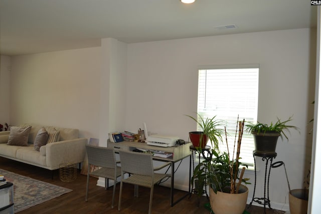 dining space featuring visible vents and wood finished floors