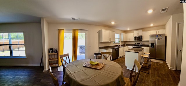 dining area with baseboards, dark wood-style floors, and visible vents