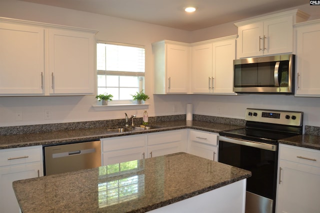 kitchen with white cabinetry, a sink, and appliances with stainless steel finishes