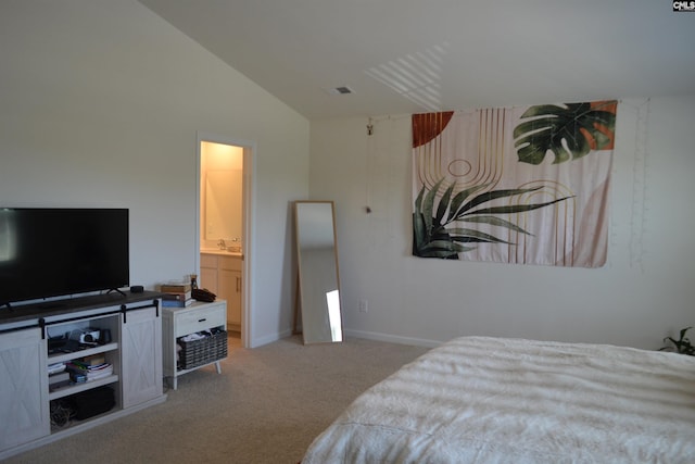 carpeted bedroom featuring visible vents, baseboards, ensuite bath, and lofted ceiling