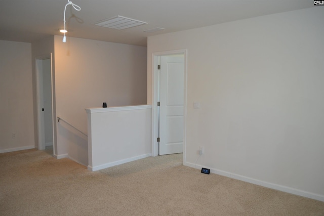 empty room with baseboards and carpet